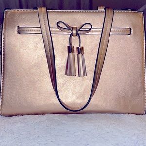 Champagne/Rose Gold tote bag with wristlet and strap to wear as a shoulder bag.